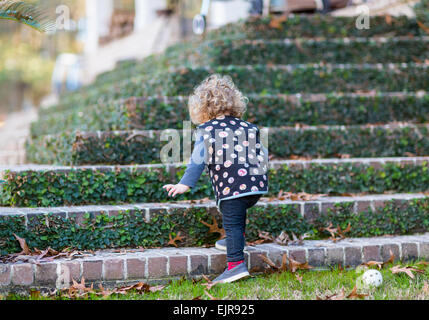 Caucasian baby boy climbing staircase Stock Photo