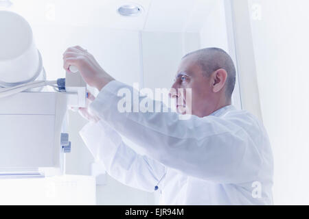 Hispanic doctor using x-ray machine Stock Photo