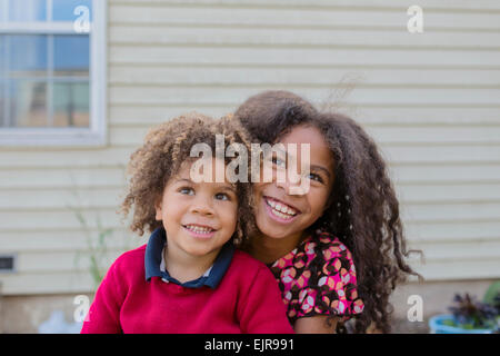 Pacific Islander brother and sister hugging outdoors Stock Photo