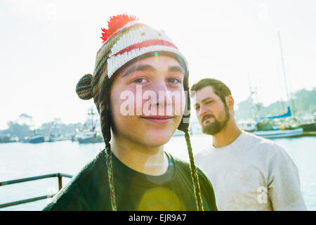 Caucasian boy wearing knitted cap in harbor Stock Photo