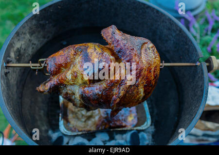 Close up of chicken cooking on rotisserie barbecue Stock Photo