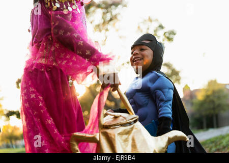 African American children trick-or-treating on Halloween Stock Photo