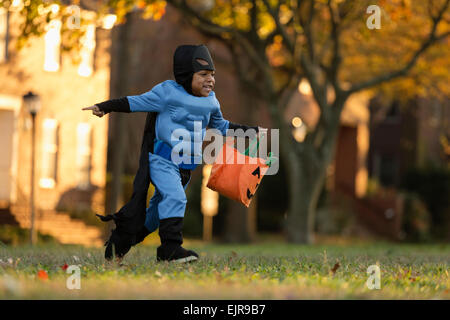 African American boy trick-or-treating on Halloween Stock Photo