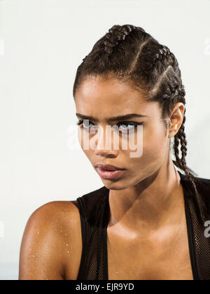 Close up of mixed race woman with braided hair Stock Photo