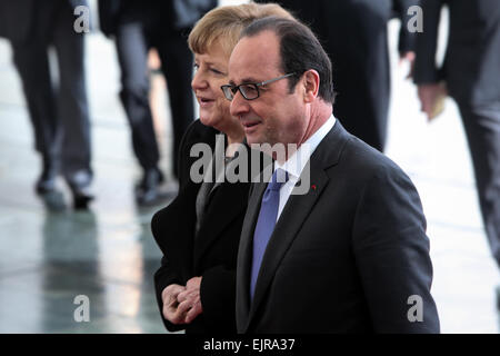 Berlin, Germany. 31st Mar, 2015. German Chancellor Angela Merkel (L) and French President Francois Hollande attend a welcome ceremony at the Chancellery in Berlin, Germany, on March 31, 2015. Credit:  Zhang Fan/Xinhua/Alamy Live News Stock Photo