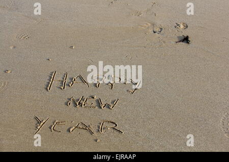 Happy New Year, Written in Sand at the Seashore Stock Photo