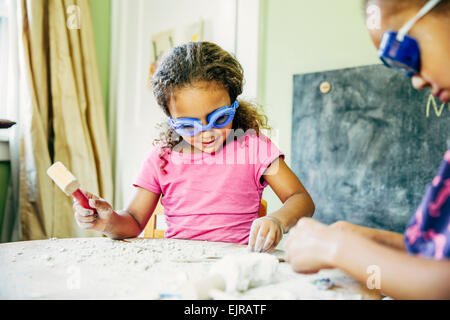Mixed race sisters doing science experiment at home Stock Photo