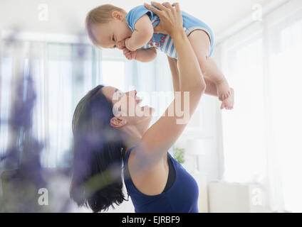 Close up of mixed race mother playing with baby Stock Photo
