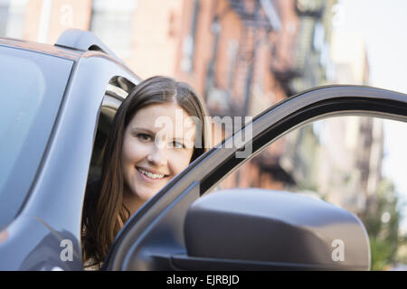 Caucasian woman opening car door Stock Photo