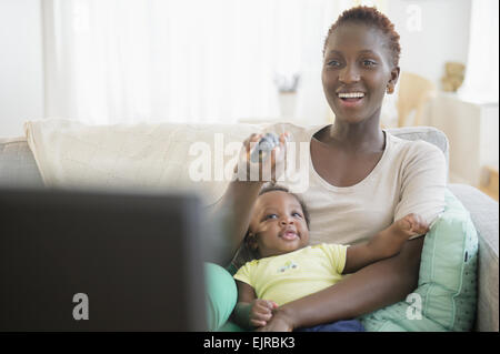 Black mother and son playing on sofa Stock Photo