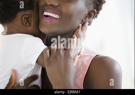 Close up of Black mother holding son Stock Photo