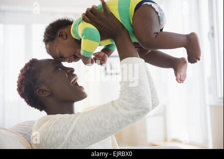 Black mother playing with baby boy Stock Photo