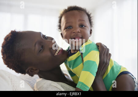 Black mother holding baby boy Stock Photo