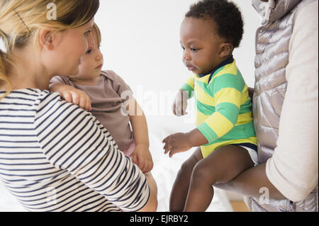 Mothers introducing babies on play date Stock Photo