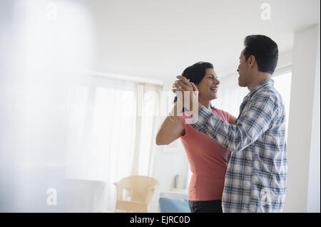 Couple dancing in living room Stock Photo