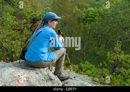 Hiker on outcrop along Mattabesett Trail, Cockaponset State Forest, Connecticut Stock Photo