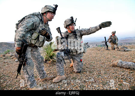 U.S. Army 1st Lt. Nicholas Gregory, kneeling, and Sgt. 1st Class Robert White discuss where to move next in Bak, Khowst province, Afghanistan, April 5, 2010. Gregory and White are assigned to the 101st Airborne Division's Company D, 3rd Battalion, 187th Infantry Regiment, 3rd Brigade. The purpose of the mission was to clear safe houses and search suspected cache sites.  Sgt. Jeffrey Alexander Stock Photo