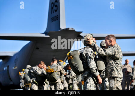 U.S. soldiers help each other inspect their equipment before a combat training jump into Bunker drop zone at the 7th Army Joint Multinational Training Command's Grafenwoehr Training Area, Germany, Oct. 22, 2013. The soldiers are assigned to 1st Squadron, 91st Cavalry Regiment, 173rd Infantry Brigade Combat Team.  Markus Rauchenberger Stock Photo