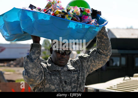 1st Sgt. Dwight D. Brown of the Mississippi Army National Guard, A Troop, 1-98th Cavalry, carries items to aid citizens of Smithville, Miss., after a tornado. Stock Photo