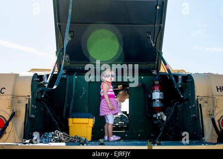 Harper Allen, 2, of Downers Grove, Illinois, stands on the back of an Army Reserve humvee belonging to the 416th Theater Engineer Command during the Touch a Truck community event hosted by the Village of Willowbrook, Parks and Recreation Department, July 11. An estimated 300 children visited and interacted with various trucks on display.  Sgt. 1st Class Michel Sauret Stock Photo