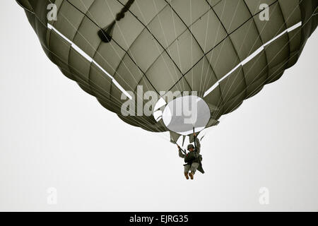 A paratrooper assigned to 4th Bn., 319th Airborne Field Artillery Regt., 173rd Infantry Brigade Combat Team Airborne conducts a training jump from a C-130 Hercules into Bunker Drop Zone at the 7th Army Joint Multinational Training Command's Grafenwoehr Training Area, Germany, Jan. 29, 2014. The paratroopers jumped in following the drop of their M109 howitzer system.  U.S. Army  Visual Information Specialist Gertrud Zach/released Stock Photo