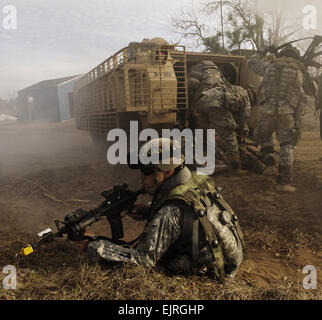 A U.S. Army Soldier from 1st Battalion, 30th Infantry Regiment, 3rd Infantry Division provides security while other Soldiers load the wounded into an armored vehicle during training at Fort Stewart, Ga., March 2, 2007.  The 3rd ID is conducting training with the assistance from observer controller teams from the National Training Center in preparation for a future deployment.  Staff Sgt. Alfred Johnson Stock Photo