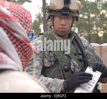 A U.S. Army Soldier from Bravo Troop, 3rd Squadron, 7th Cavalry Regiment, 3rd Infantry Division uses his smart cards to speak Arabic to a simulated local Iraqi national during training at Fort Stewart, Ga., March 3, 2007.  The 3rd ID is conducting training with the assistance from observer controller teams from the National Training Center in preparation for a future deployment.  Spc. Nicholaus Williams Stock Photo