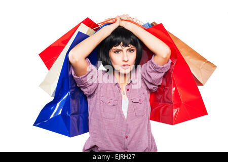 exhausted woman with shopping bags over her head Stock Photo