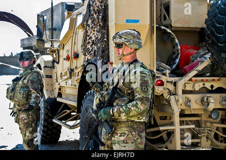 Staff Sgt. Scott Cunningham, the provincial headquarters-Kandahar security force assistance team convoy commander in Battery A, Field Artillery Squadron, 2nd Cavalry Regiment, motions to load up the trucks as the convoy prepares to leave the old provincial headquarters building in Kandahar City, Afghanistan, Oct. 28, 2013. An SFAT team met with Afghan Uniformed Police Oct. 28 to train and assist them as they take the lead in providing security for the people of Afghanistan. U.S. Army  Cpl. Clay Beyersdorfer Stock Photo