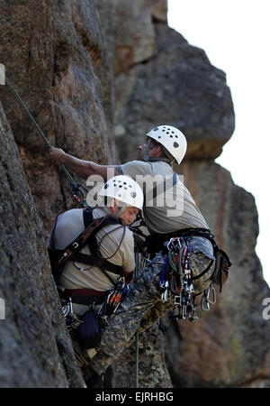 Soldiers attending the U.S. Army Special Forces Command A Mountaineering Program conduct Senior Course Level II  training near Fort Carson, Colo., after completing the Basic Course Level III where team members learned 15 basic tasks, including navigating in mountainous terrain, rope commands, transportation of a casualty on an improvised litter and rappelling techniques. During Level II, the soldiers are expected to know and pass a hands-on test on the basic fundamentals of rock climbing throughout the course. Among the 17 tasks in the Senior Course they must be proficient at constructing a be Stock Photo