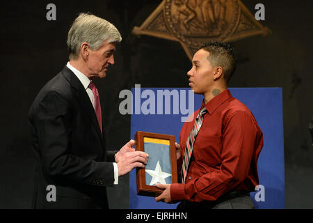 Secretary of Army John McHugh presents the Medal of Honor Flag to Sgt. Ashley Randall, on behalf of her grandfather Pvt. Demensio Rivera, one of 24 Army veterans honored during the Valor 24 Hall of Heroes Induction ceremony, held at the Pentagon, Washington D.C., March 19, 2014.  Mr. Leroy Council Stock Photo