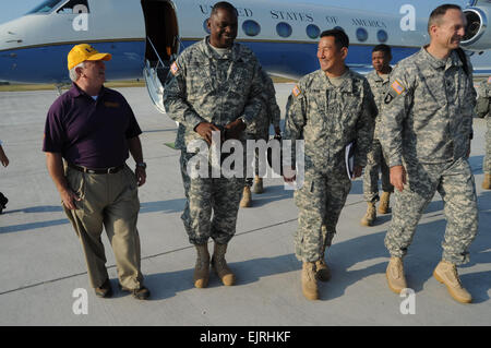 Vice Chief of Staff of the Army Gen. Lloyd A. Austin III, arrives at Alexandria International Airport near Fort Polk, Louisiana. Greeting him is Brig. Gen. K.K. Chinn, commanding general of the Joint Readiness Training Center and Fort Polk. At left is Charles Elliott, manager of Millionaire air operations. Austin arrived at Fort Polk Oct. 11 to observe the first JRTC and Fort Polk Decisive Action rotation and meet with Soldiers on resilience, readiness and the health of the force. Stock Photo