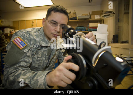 U.S. Army Spc. Anthony Fountain, with the Naval Ophthalmic Support and Training Activity in Yorktown, Va., uses a manual lensometer at Coast Guard Integrated Support Command Kodiak, Alaska, March 5, 2008. Fountain is helping to create 400 pairs of free eyeglasses for patients during Operation Arctic Care 2008, an annual joint-service training event that provides medical, dental, optometry, veterinary and mechanical services to Kodiak.  Master Sgt. John R. Nimmo, Sr. Released Stock Photo