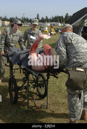 Chemical patient triage  AF Tech.Sgt. Larry Simmons May 06, 2008  Combat medics from the 601st Area Support Medical Company from Fort Bragg, N.C., triage a chemical burn victim after finishing a deconamination procedure. The scenario was part of a National Level Exercise conducted in the Seattle, Wash., area to test the ability of federal response to a mass casualty situation. Stock Photo