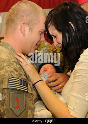 Pfc. Jordan Boswell and his wife Tifany hold their 9-day-old son Conner Oct. 21 following a welcome home ceremony at Fort Riley, Kan. Boswell and more than 250 of his fellow Soldiers from 1st Battalion, 7th Field Artillery Regiment, 2nd Heavy Brigade Combat Team, 1st Infantry Division were returning from a 12 month deployment to Iraq and were some of the Dagger Brigade's first Soldiers to arrive back at Fort Riley. The remainder of the brigade's 3,000 Soldiers will continue to return to Central Kansas throughout the next several weeks.  Mollie Miller, 1st Infantry Division Public Affairs Stock Photo