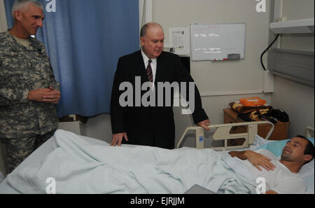 U.S. Army Europe Commander Lt. Gen. Mark P. Hertling and Under Secretary of the Army HON Dr. Joseph W. Westphal meet a Wounded Warrior during their Nov. 22, 2011, visit with staff and patients at Landstuhl Regional Medical Center, Germany. Photo Credit by LRMC Public Affairs Stock Photo