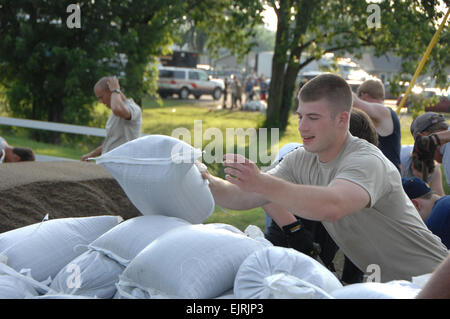 National Guard Responds to Indiana Flooding  Spc. William E. Henry June 09, 2008  Specialist Joseph Stamm, 1st Battalion, 151st Infantry, helps citizens load sandbags into their vehicle in Martinsville, Ind., Saturday, June 7, 2008. Flash floods tore through the area after over 10 inches of rain poured over the already saturated land. Stock Photo