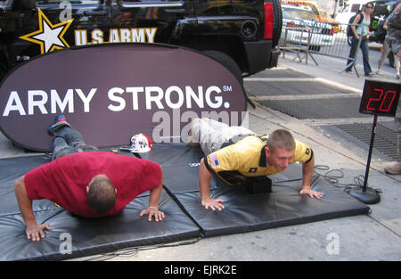 Marksman Competes in Pushups  courtesy June 19, 2008  Pfc. Vincent Hancock right, who has qualified to compete in Skeet at the Olympic Games in Beijing, competes here in a push-up contest with a member of the public in Times Square, New York.   see: /-news/2008/06/19/10202-army-olympians-compet...  /-news/2008/06/19/10202-army-olympians-compete-with-pedestrians-at-times-square/ Stock Photo