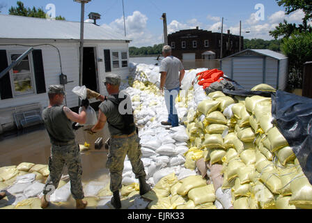 Illinois Army National Guard soldiers reinforce a sandbag wall protecting homes of residents of Hamburg, Ill., on June 20, 2008.  The troops are deployed to support flood relief efforts along the Mississippi River.   Tech. Sgt. Dawn M. Anderson, U.S. Air Force.  Released Stock Photo