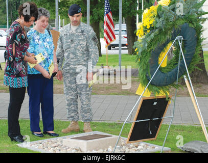 Capt. Renato Vieira, 554th Military Police Company commander, shows Kathy Brelsfoard, left, and Carol Ann Clifton, both of Decatur, Ill., a memorial plaque honoring Cpl. Karen Clifton, Brelsfoard's niece and Clifton's granddaughter. Clifton, 22, was killed in Baghdad, Iraq, June 21, 2007, when a rocket-propelled grenade hit her vehicle and exploded. Building 2914 on Panzer Kaserne, the home of the 554th MPs, was renamed Clifton Hall at a ceremony June 20.  Susan Huseman  see: /-news/2008/07/09/10734-stuttgart-mps-dedicat...  /-news/2008/07/09/10734-stuttgart-mps-dedicate-building-to-fallen-sol Stock Photo