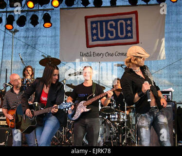 Gina Gonzalez, Gary Sinise, and Jeff Vezain perform as part of the Lt. Dan Band at U.S. Army Garrison Schweinfurt, Germany, July 7. Sinise is also co-founder of Operation Iraqi Children, which provides school supplies to children in areas being served by deployed U.S. forces, such as Iraq and Afghanistan. Last fall, the 1st Squadron, 91st Cavalry Airborne, headquartered in Schweinfurt, distributed 2,048 school supply packages to children in Afghanistan.  Kimberly Gearhart  see: /-news/2008/07/14/10841-sinise-entertains-tro...  /-news/2008/07/14/10841-sinise-entertains-troops-supports-children/ Stock Photo
