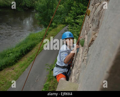 Children of Deployed Servicemembers Attend Sports, Fitness Camp  Ray Johnson June 25, 2008  Tristan Zuniga, 13, of Katterbach, Germany, scales a 500-year-old building located along the Kyll River near Bitburg. Zuniga was one of 79 youth who participated in Camp A.R.M.Y. Challenge, a program for children of deployed servicemembers in Europe. Stock Photo