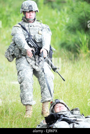Spc. Anthony Landoll, a medic with 5th Squadron, 7th U.S. Cavalry Regiment, 1st Brigade Combat Team, 3rd Infantry Division, drags a fellow Soldier into safety during an evacuation under fire exercise held at Evans Army Airfield, Aug. 21. Medics with the 1st BCT underwent the Tactical Medic Course, Aug. 18-22.  Pvt. Jared Eastman, 1st BCT Public Affairs