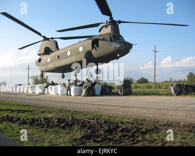 Sandbags weighing 4,000 pounds each are hooked to an Army National Guard CH-47 Chinook helicopter to repair a broken levee southeast of New Orleans, La., Sept.6, 2008. The levee was damaged by Hurricane Gustav. Official  Sgt. Brian Cooper, 2nd Battalion, 135th Aviation Regiment, Colorado Army National Guard Stock Photo