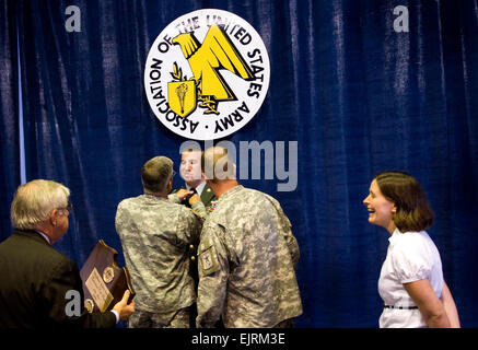 Chief of Staff of the Army, GEN. George W. Casey, Jr., and the Sgt. Maj. of the Army Kenneth Preston adjust  Staff Sgt. Herbert Thompson's tie before awarding him the 2008 Drill Sgt. of the Year award in Washington D.C., on Oct 7, 2008.  Army photo by D. Myles Cullen released Stock Photo