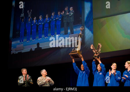 Chief of Staff of the Army, GEN. George W. Casey, Jr., and the Sgt. Maj. of the Army, Kenneth Preston present the Commander's Cup to the the winning female team from Fort Bragg for their performance in the Army Ten-Miler at the Association of the United States Army AUSA annual meeting in Washington D.C., on Oct 6, 2008. Army photo by D. Myles Cullen released Stock Photo