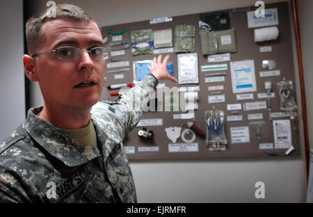 Staff Sgt. Ryan Watson, an assistant senior instructor at the Department of Combat Medic Training, discusses the many medical devices now carried by combat medics in battle. Watson said that the more realistic training at the school gives the medics more of an overall view of what they will encounter on the battlefield.  Fred W. Baker III Stock Photo