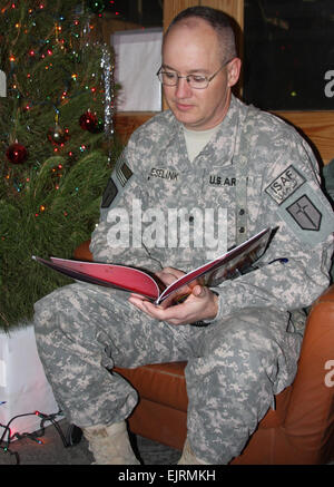 Lt. Col. Stephen Jeselink, Task Force Warrior deputy commander, is recorded while reading the poem 'The Night Before Christmas'; at the USO at Bagram Airfield, Afghanistan, Dec. 16, 2008. Through the United Through Reading military program, the Jeselink family in Louisiana will be able to continue a long-standing holiday tradition of listening to Stephen read the poem on Christmas Eve. Stock Photo