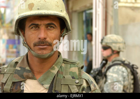 JOINT SECUIRTY STATION ZAFARANIYA, Iraq – An Iraqi Army soldier assigned to 1st Company, 2nd Battalion, 37th Regiment, 9th Infantry Division conducts a patrol in a neighborhood in the Al Karradhah district of eastern Baghdad, Dec 31. IA soldiers were assisted in the counter-improvised explosive device operation by Paratroopers assigned to Battery B, 1st Battalion, 319th Airborne Field Artillery Regiment, 3rd Brigade Combat Team, 82nd Airborne Division, Multi-National Division – Baghdad. Under the security agreement Iraqi Security Forces will now oversee all military operations in Iraq.   Staff Stock Photo