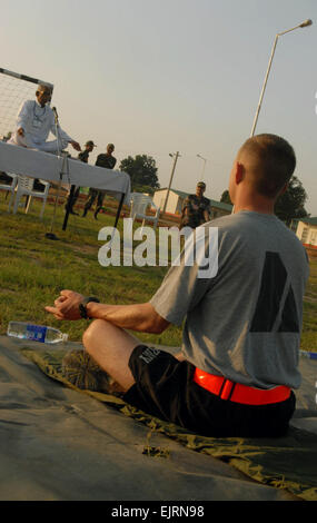 Soldiers assigned to Troop B, 2nd Squadron, 14th Cavalry Regiment, &quot;Strykehorse,&quot; 2nd Stryker Brigade Combat Team, 25th Infantry Division, listen to a yoga instructor during their yoga session at Camp Bundela in Babina, India, Oct. 11. The instruction is part of a cultural exchange between the Indian Army and the U.S. Army. The Soldiers are in India in support of Exercise Yudh Abhyas 09. YA09, which is scheduled for Oct. 12-27, is a bilateral exercise involving the Armies of India and the United States. The primary goal of the exercise is to develop and expand upon the relationship b Stock Photo